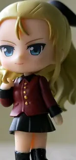 Cute anime figure with blonde hair in a maroon outfit.