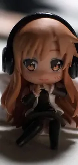 Chibi anime figure with headphones close-up wallpaper.