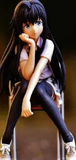 Anime girl figure sitting on a chair with blurred background.