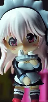 Anime maid figurine with pink hair and headphones.