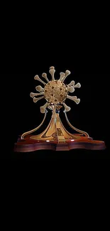 Sculpture of antique phone on wooden base with gold detailing.