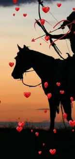 Silhouette of an archer on horseback with a sunset background.