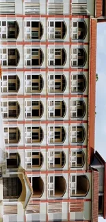 Photo of a beige and red multi-story building exterior.