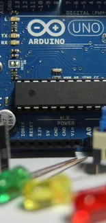 Close-up view of Arduino Uno circuit board, featuring microcontroller and components.