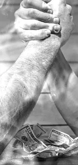 Black and white arm wrestling scene with cash on the table.