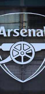 Arsenal logo on a textured background wallpaper.