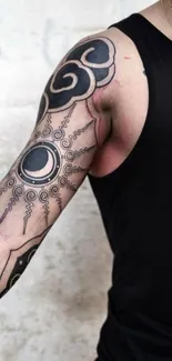 Arm showcasing intricate black ink tattoo design.