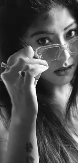 Black and white portrait of a woman wearing glasses.