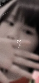 Blurred background with a heart hand gesture.