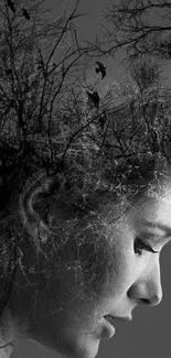 Double exposure art blending human profile with trees in black and white.