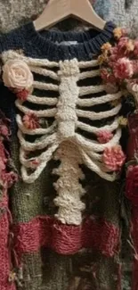 Knit sweater with skeletal and floral design.