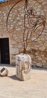 Rustic stone wall with artistic metal sculpture.