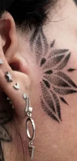 Tattoo design on face with artistic details, earrings visible.