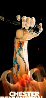 Illustrative tattooed arm holding microphone on black background.