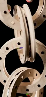 Artistic wooden rings on a black background.