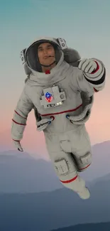 Astronaut in space floating against a mountain backdrop.