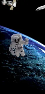 Astronaut floating above Earth in space wallpaper.