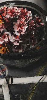 Astronaut helmet filled with pink flowers and butterflies on black background.