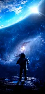 Astronaut standing under a vibrant blue galaxy with Earth overhead.