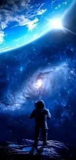 Astronaut gazing at a vast, blue cosmic universe.