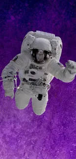 Astronaut floating against a purple cosmic background.