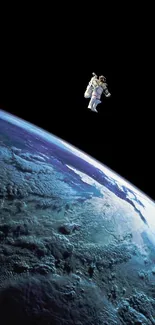 Astronaut floating in space above Earth in stunning mobile wallpaper.