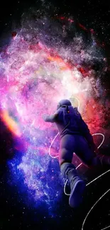 Astronaut floating through a colorful, vivid nebula in space wallpaper.