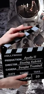 Astronaut on moon with film clapperboard.
