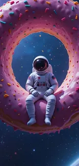 Astronaut sitting on a giant pink donut in space.