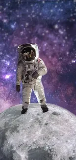 Astronaut standing on moon with starry purple nebula background.