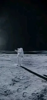 Astronaut standing on the moon under a dark, starry sky.