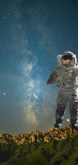 Astronaut on a mountain under a starry sky with the Milky Way in the background.