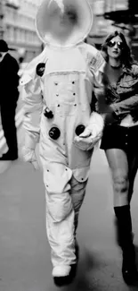 An astronaut walks down a city street with a woman, in a monochrome photograph.