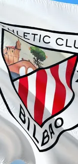 Athletic Club Bilbao flag waving against blue sky.