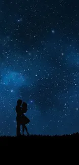 Silhouette of a couple embraced under a dark blue starry night sky.