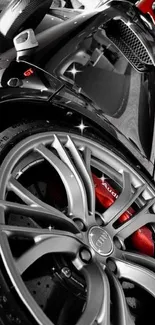 Close-up of a black Audi sports car wheel with red brake calipers.