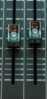 Closeup view of an audio mixer slider control panel.