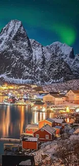 Northern lights over snowy village and mountains.