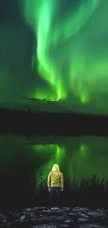 Person under vibrant green aurora against a night sky.