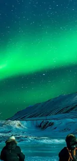 Aurora borealis over snowy mountains under a star-filled night sky.