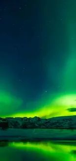 Vibrant aurora borealis over snowy mountains reflecting in a serene lake.