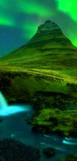 Aurora Borealis over a mountain with a waterfall and stream at night.