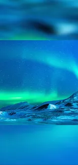 Northern Lights over snowy mountains with vibrant blue and green hues.