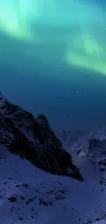 Aurora lights over snowy mountains at night.