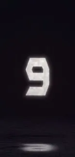 Minimalist dark wallpaper featuring a glowing number nine on a black background.