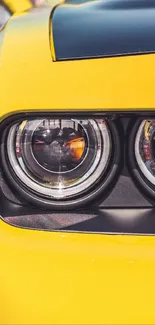 Close-up of a yellow sports car headlight, emphasizing modern design.