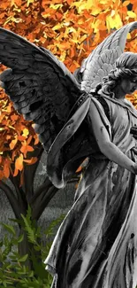 Stone angel sculpture with vibrant autumn leaves background.