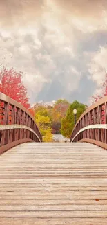 Serene wooden bridge in autumn with golden clouds.