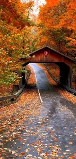 Covered bridge surrounded by autumn leaves and vibrant trees.