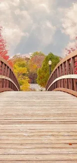 Wooden bridge surrounded by autumn leaves.